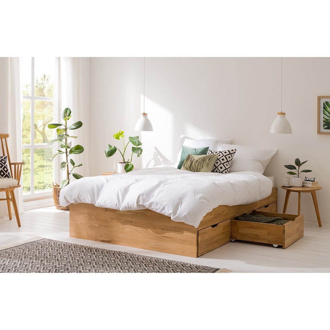 Solid oak bed with storage drawers in a bright, minimalist bedroom.